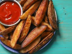 french fries with ketchup on a blue plate