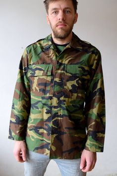 "Camouflage jacket, hunting shirt, military shirt, army topcoat, olive greet, outdoor jacket, outwear, men khaki green, women oversized, M/L Military camouflage button-up jacket. Jacket has two chest pockets. Authentic military in excellent condition. Size: seems like men (M) and women (L) Measurements: Length: 78 cm/ 31\" Shoulder to shoulder: 49 cm/ 19\" Sleeve: 60 cm/ 24\" Bust: 114 cm/ 45\" Condition: excellent Brand: authentic military Fabric: polyester, cotton * Wash at temperature not hig Military Shirt, Camouflage Jacket, Military Camouflage, Spring Coat, Tracksuit Jacket, 90s Shirts, Army Jacket, Cozy Pullover, Hunting Shirts