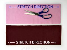 a pair of scissors sitting on top of a pink and brown piece of cloth next to each other