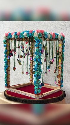 an elaborate display with flowers and beads on it