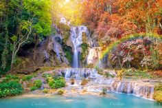 a beautiful waterfall surrounded by trees and water