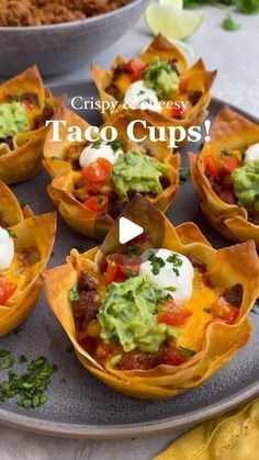 taco cups are sitting on a plate with guacamole and sour cream