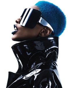 a woman with blue hair wearing a black latex outfit and blindfolded headgear