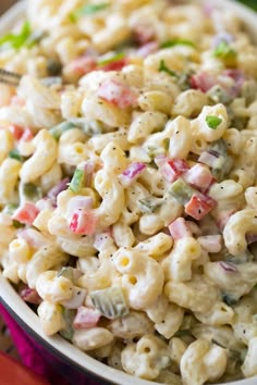 a bowl filled with macaroni salad on top of a table