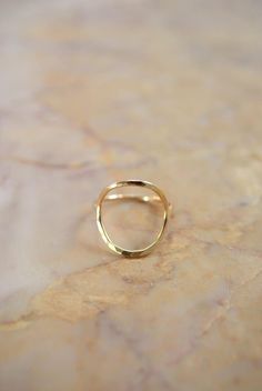 This item is made to order and will ship after 7-10 business days. That time does not include holidays, weekends or shipping time!This item is hand-crafted by the designer herself and made to order in Portland, OR.This Skinny Gold Infinity ring is definitely a new favorite! I twist a length of 14kt Gold metal into a circular shape and lightly hammer it. The hammered effect adds lots of shine and sparkle, so even through the wire itself is very light and feminine, the ring has a big impact overal Hammered 14k Gold Stackable Rings, Elegant Hammered Round Rings, Modern Hammered Stackable Rings, Modern Hammered Yellow Gold Rings, Elegant Everyday Open Circle Rings, Elegant Open Circle Rings For Everyday, Elegant Everyday Rings With Open Circle Shape, Modern Gold Open Circle Ring, Elegant Gold Open Circle Ring