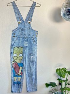 Vintage bootleg Bart Simpson Skateboard Airbrushed overalls Feminine fit with a torso that falls below the bust Would best fit someone 5'3" or shorter Tag reads Sergio, no size. Likely a girls 16 50" length 28" waist 17" length shoulder to waist 34" pant length 26" inseam 8" rise Retro Fitted Overall Bottoms, Retro Fitted Overalls, Fitted Retro Overalls, Vintage Fitted Overall Jeans, Vintage Denim Overall Jumpsuit For Fall, Vintage Fitted Overalls, Bootleg Bart, Girls 16, Pant Length