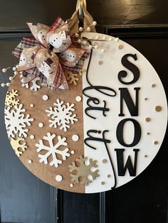 a door hanger decorated with snow and christmas decorations