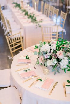 the table is set with place cards and flowers