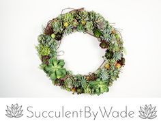 the succulent by wade logo is displayed in front of a circular wreath with green plants