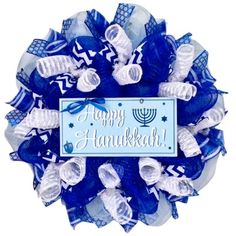 a happy hanukkah wreath with blue and white mesh decorations on the front door