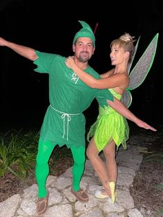 a man and woman dressed up as tinkerbells