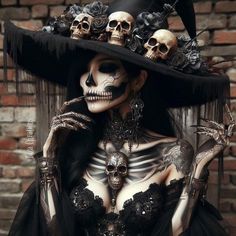 a woman in skeleton makeup and black dress with skulls on her head, wearing a large hat