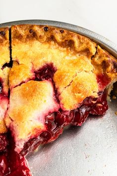 a close up of a pie on a pan with one slice missing from the pie