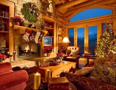 a living room filled with furniture and a fire place in front of a christmas tree