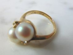 A LOVELY, WOMEN'S VINTAGE 14K GOLD RING WITH WHAT APPEARS TO BE PEARLS ACCENTED WITH TWO TINY DIAMOND CHIPS. NOT 100% SURE IF THE PEARL IS REAL OR NOT. THE DIAMONDS ARE REAL, ABOUT .02cts. THE RING IS A SIZE 3, AND WEIGHS 4.1g. THIS IS A BEAUTIFUL, IMPRESSIVE GIFT FOR THAT SOMEONE SPECIAL. ANY OTHER QUESTIONS, PLEASE DON'T HESITATE TO ASK. BE SURE TO CHECK OUT SOME OF MY OTHER GREAT ITEMS UP FOR SALE. THANK YOU. IF THERE ARE ANY ISSUES PLEASE CONTACT US, WE'RE ALWAYS HAPPY TO TRY TO HELP YOU OUT Heirloom High Luster Rings For Anniversary, High Luster Rings For Anniversary, 14k Gold High Luster Wedding Rings, Anniversary Pearl Ring With 17 Jewels, Heirloom Jewelry With High Luster For Anniversary, Yellow Gold Wedding Rings With High Luster, High Luster Pearl Ring For Anniversary, Vintage High Luster Rings For Anniversary, Heirloom Pearl Anniversary Ring