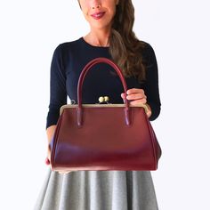 "Indulge in timeless elegance with our Top Handle Purse \"Sophie\" in burgundy red - a kiss lock bag that effortlessly blends vintage and retro charm. This stylish and noble womens leather bag, featuring a clip closure, is designed for the modern woman who appreciates both fashion and functionality. Exquisite Craftsmanship: Handbag Sophie boasts an outer material of genuine smooth cowhide. Smooth leather not only exhibits a bright color but also offers a warm surface and a noble appearance, making every outing a statement of sophistication. Thoughtful Features: Two sturdy handles, approximately 15 inches (40 cm) long, provide a comfortable and stylish carrying option. The removable, length-adjustable shoulder strap (max. 47 inches / 120 cm) offers versatile ways to wear. Inside, discover a Red Leather Bag, Bridal Jewelry Vintage, Red Leather Handbags, Red Purse, Retro Accessories, Handbag Vintage, Vintage Leather Bag, Red Purses, Handbag Leather