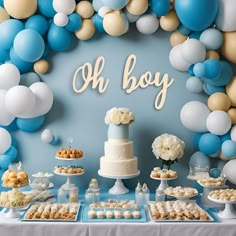 a baby shower party with blue and white balloons, desserts, and cake on a table