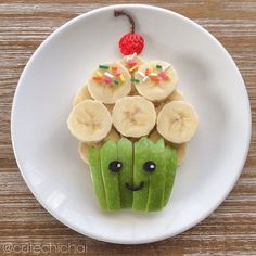 a white plate topped with cut up bananas and kiwi slices on top of each other