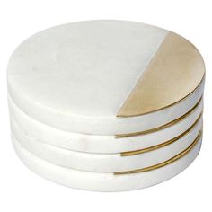 four white and gold coasters stacked on top of each other