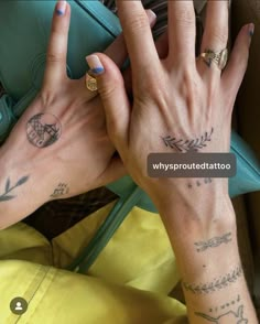 two hands with tattoos on their fingers and one hand holding a purse in front of them