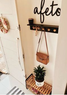 a potted plant sitting on top of a wooden crate next to a wall mounted shelf