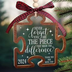 a christmas ornament hanging from a tree with a message on it that reads, never forget you are the piece that made the difference