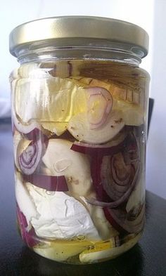 a jar filled with pickled onions on top of a table