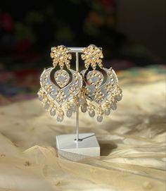 A perfect grey kundan/chandbali earring for your next event! Luxury Meenakari Temple Jewelry Pearl Earrings, Silver Chandbalis With Stone Work For Eid, Silver Stone Work Chandbalis For Eid, Silver Stone Work Danglers For Eid, Eid Chandbali Bridal Earrings With Mirror Work, Eid Bridal Chandbali Earrings With Mirror Work, Eid Chandbalis With Stone Work In Silver, Silver Danglers With Stone Work For Eid, Festive Silver Chandelier Earrings With Stone Work