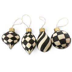 three black and white checkered ornaments hanging from twine strings on a white background