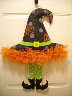 a halloween witch doll hanging on the front door