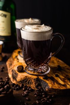 two cups of coffee sit on a cutting board