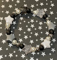 Get lost in a galaxy far away with this plastic Star beaded bracelet. Accented with glass pearl and silver colored spacer beads is sure to add an out of this world sparkle to your park day outfit!   Bracelets are available in a variety of lengths.  Pick your custom length from the drop down menu below.  All our bracelets are made with quality in mind.  With that being said, all bracelets should be treated with care while putting on, wearing, and taking off.  Keep dry. Do not swim or bath with th Pretty Bead Jewelry, Bracelet With Stars, Star Bracelet Diy, Beaded Star Bracelet, Star Bracelet Bead, Star Beads Bracelet, Outfit Accessories Ideas Jewelry, Silver Beads Bracelet, Alt Bracelets