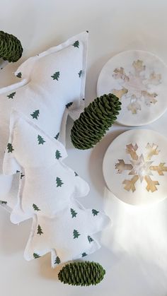 pine cones are sitting on top of napkins with snowflakes in the background