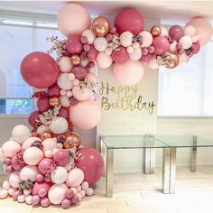 a bunch of balloons that are in the shape of a birthday arch with pink, white and gold balloons