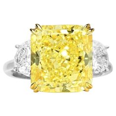 An important ring comprising of a radiant diamond weighing 4 carats. The diamond is certified by GIA stating that it's of fancy yellow color, VVS clarity. It's accented by two half-moon diamonds on both sides weighing a total of 0.70 carats. Metal: white and yellow 18k gold. Canary Diamond Engagement Ring, Canary Yellow Diamonds, Radiant Cut Diamond Ring, Radiant Cut Rings, Canary Diamond, Yellow Diamonds Engagement, Yellow Diamond Engagement Ring, Yellow Diamond Rings, Yellow Engagement Rings