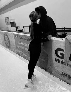 a man and woman standing next to each other on an ice rink