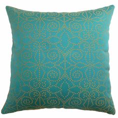 a green pillow with gold dots on it