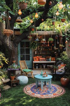 an outdoor patio with potted plants and hanging lights above the table, surrounded by greenery