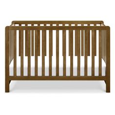 a wooden crib with white sheets on the bottom and side rails, in front of a