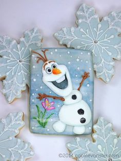 some cookies with frosting on them are decorated like characters from frozen princess and the snow queen