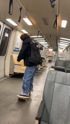 a man riding a skateboard down a train