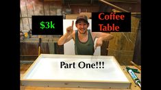 a man standing in front of a table with two signs on it that say coffee table and part one