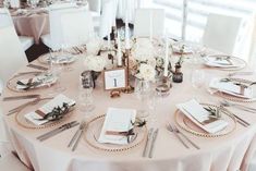 the table is set with silverware and place settings for guests to sit down at