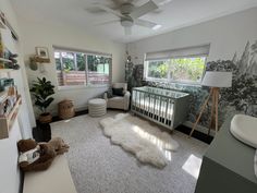 a baby's room is decorated in gray and white