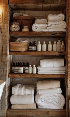 the shelves in this bathroom are filled with towels and other items, including soaps