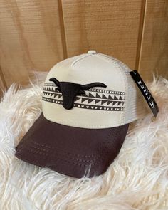 Cinch Ladies Trucker Cap is a lightweight and cool hat with mesh back and easy fit with adjustable tab in back. Classic baseball cap style from Cinch has a raised embroidered steerhead and aztec style design in front, solid brown color bill, and solid cream color mesh back. Great colors and patterns are designed to coordinate easily with Ladies Cinch apparel. Adjustable snap back Lightweight and breathable mesh Cool color combinations Western Style Adjustable Baseball Cap With Curved Brim, Adjustable Western Baseball Cap For Rodeo, Country Style Adjustable Baseball Cap For Rodeo, Adjustable Country Style Baseball Cap For Rodeo, Adjustable Western Snapback Hat With Curved Brim, Western Style Adjustable Snapback Hat With Curved Brim, Adjustable Snapback Hat With Curved Bill For Rodeo, Western Style Outdoor Snapback Hat, Adjustable Baseball Cap With Curved Bill For Rodeo