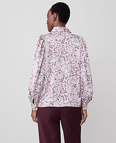 Elevate your wardrobe with the Ann Taylor Paisley Collared Puff Sleeve Shirt, a perfect blend of sophistication and playful style. This lilac shirt for women is designed to make a statement with its unique puff sleeves and elegant paisley pattern.

- **Size:** Medium
- **Color:** Lilac
- **Material:** 100% Polyester
- **Gender:** Female
- **Sleeve Type:** Long sleeves with shirred sleeve caps and button cuffs
- **Closure:** Button front
- **Length:** 24 1/2 inches long
- **Care Instructions:** M Plus Size Blouses For Women Tunic Tops, Plus Size Blouses For Women, Shirred Sleeve, Women Tunic, Ann Taylor Petite, Puff Sleeve Shirt, Women Tunic Tops, Petite Tops, Button Front Shirt