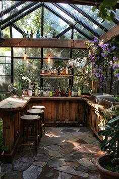 an outdoor kitchen with lots of counter space and plants in the back ground, surrounded by greenery