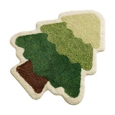 three trees shaped rugs on top of each other, one green and one brown