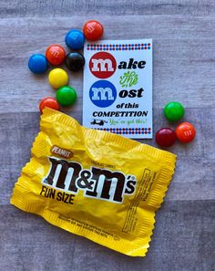 m & m's candy is on the table next to some other candies